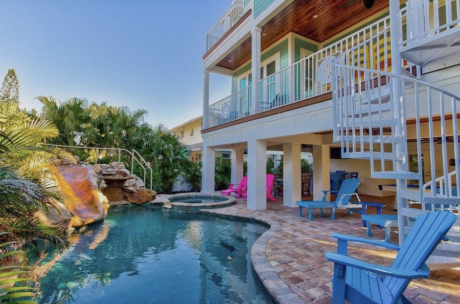 Colourful multi-level rental home with a rock waterfall slide, spa and pool